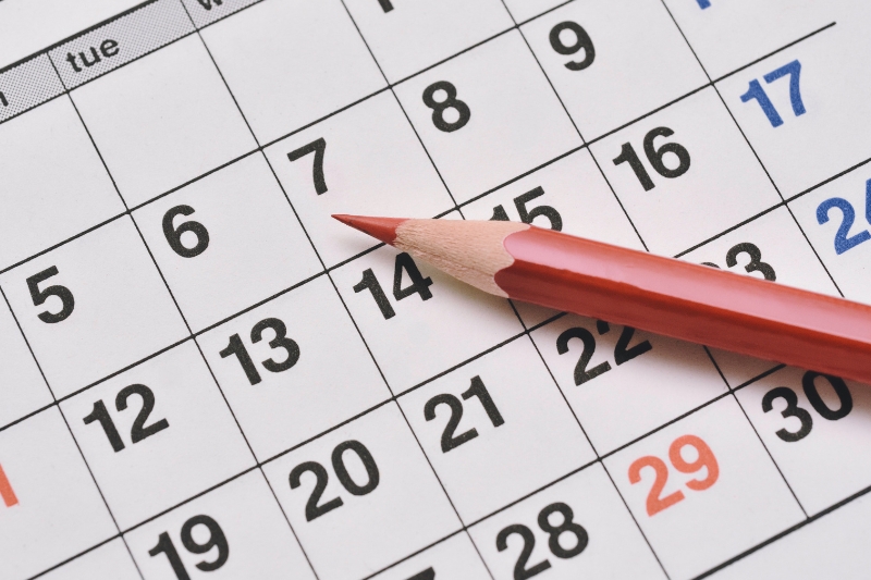 Closeup photo of a calendar with a pencil resting on it