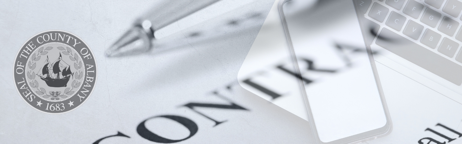 stylized black and white photographic graphic of various business elements including a contract, a laptop, a cellphone and a pen