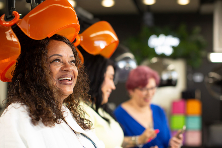 Photo of smiling people at an outdoor gathering.