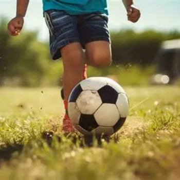 Child dribbling a soccer ball